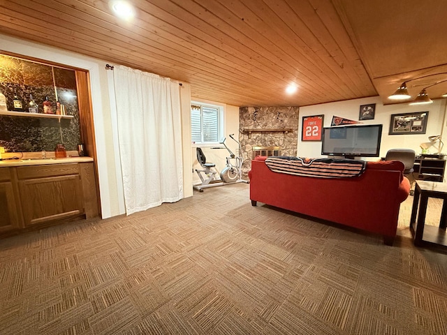 carpeted living room featuring a fireplace, bar, and wood ceiling