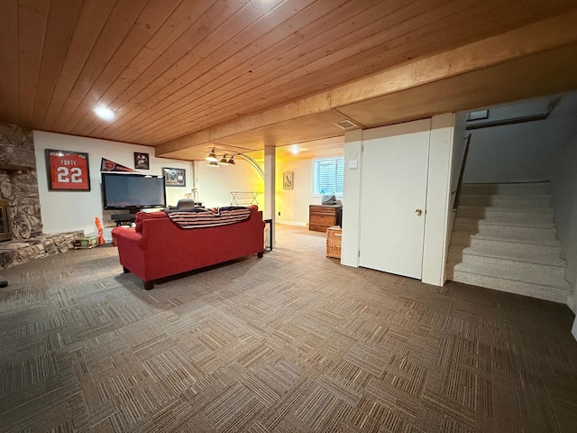 carpeted living room with a fireplace and wood ceiling