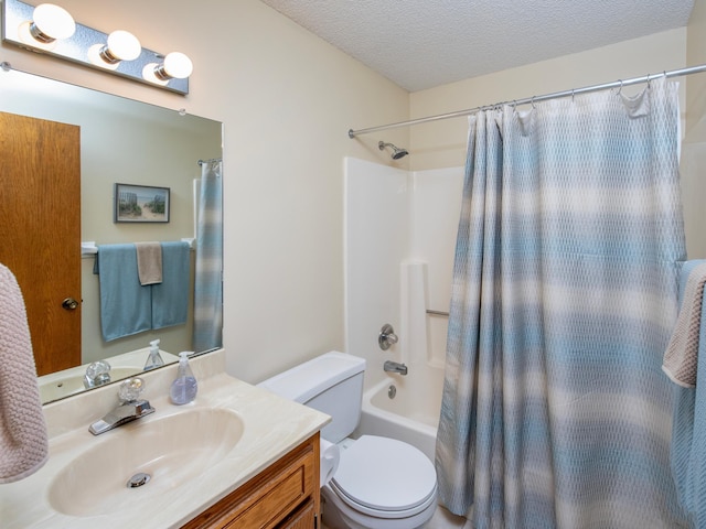 full bathroom featuring toilet, a textured ceiling, vanity, and shower / bathtub combination with curtain