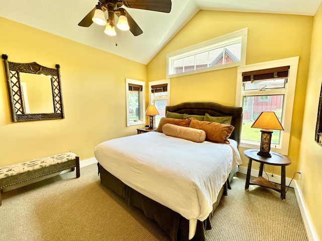 carpeted bedroom with vaulted ceiling, multiple windows, and ceiling fan