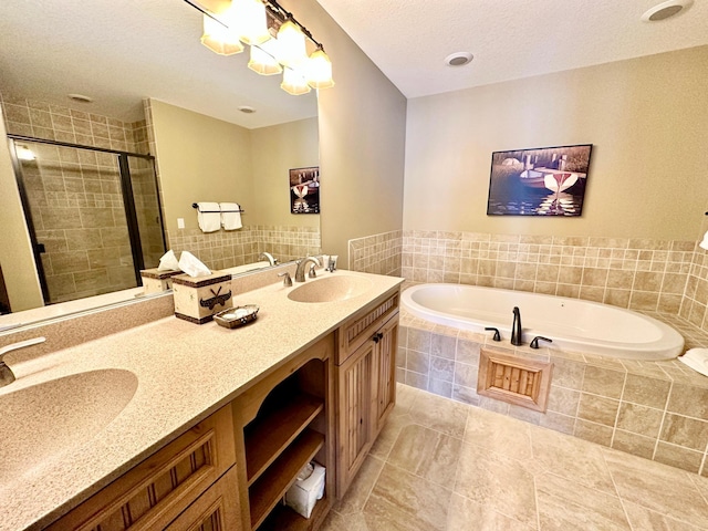 bathroom featuring vanity, a textured ceiling, shower with separate bathtub, and tile patterned floors