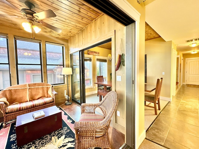 sunroom / solarium with ceiling fan and wooden ceiling