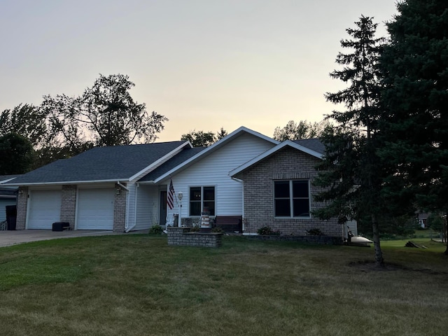 view of front of home featuring a lawn and a garage