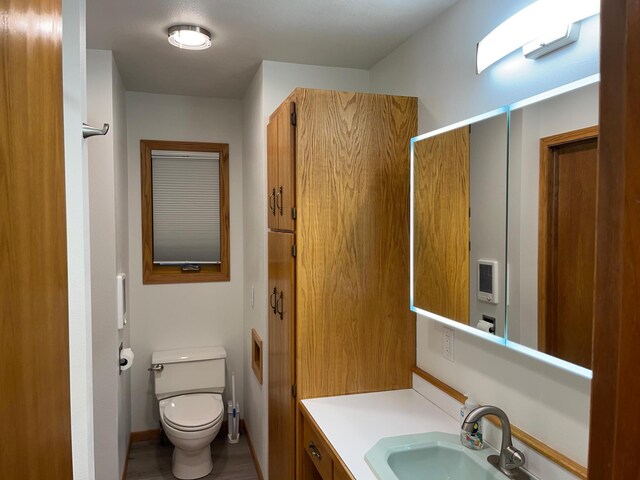 bathroom featuring vanity and toilet