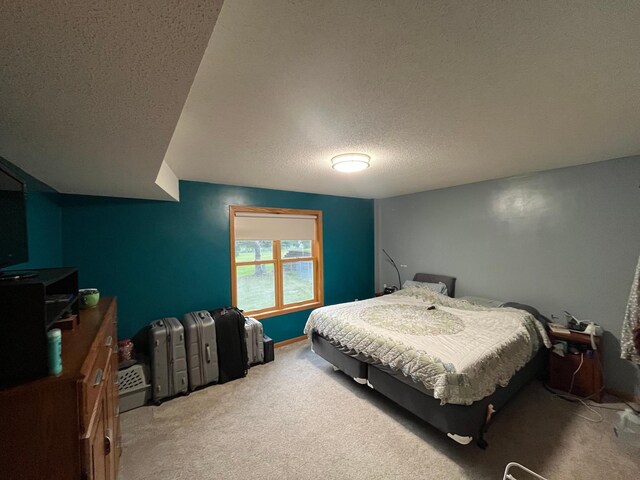 carpeted bedroom featuring a textured ceiling