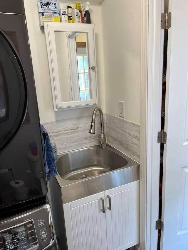 kitchen featuring white cabinetry and sink