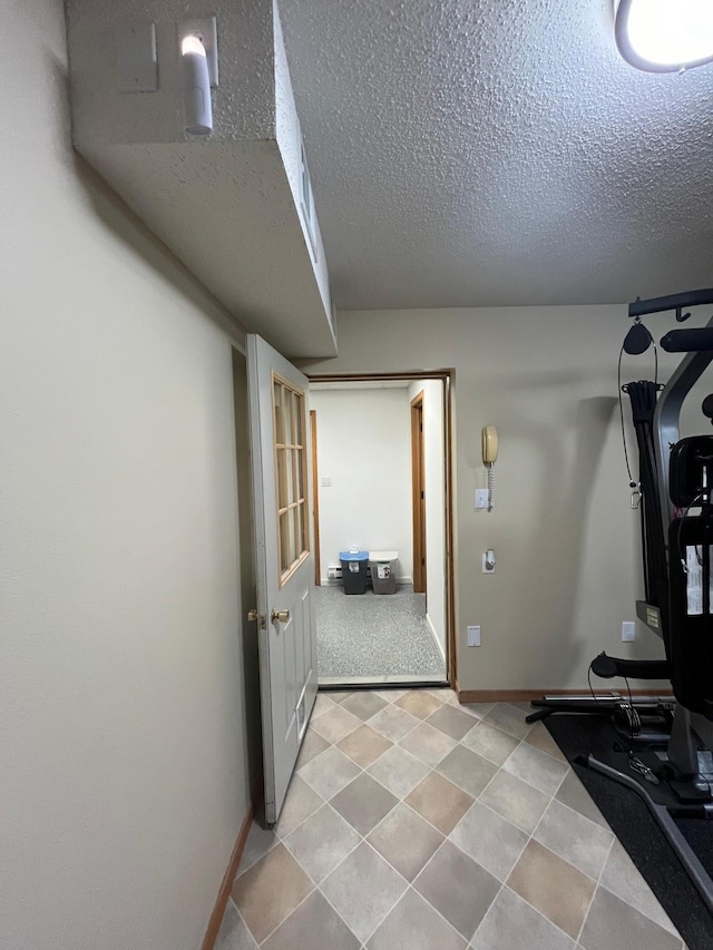 exercise room featuring a textured ceiling