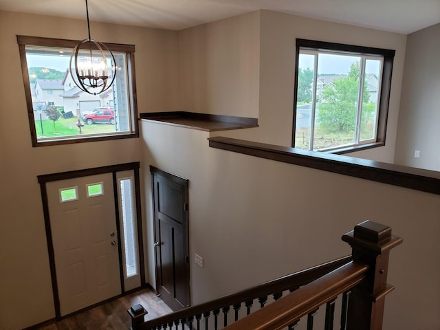 entryway featuring hardwood / wood-style floors and a notable chandelier