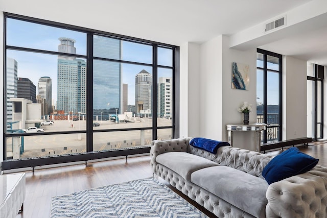 living room with hardwood / wood-style floors and expansive windows