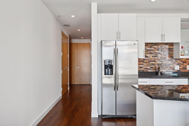 kitchen featuring dark wood finished floors, tasteful backsplash, stainless steel refrigerator with ice dispenser, and a sink