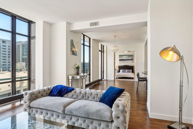 interior space featuring baseboards, a notable chandelier, dark wood-style flooring, and floor to ceiling windows