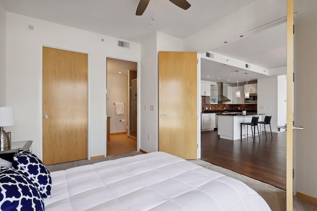 bedroom with baseboards, visible vents, and light wood-type flooring