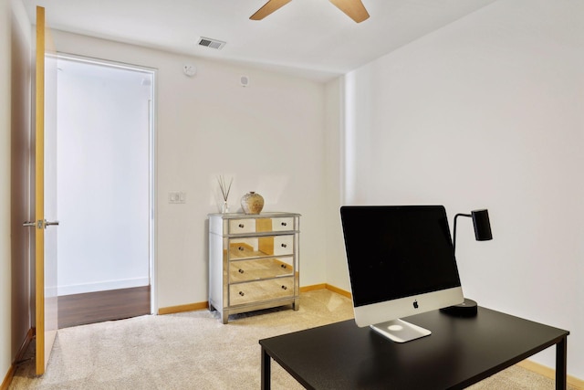 office featuring visible vents, baseboards, light colored carpet, and ceiling fan