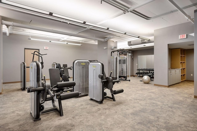 workout area with baseboards and carpet flooring