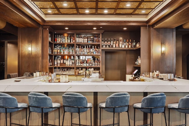 bar with beamed ceiling, a community bar, coffered ceiling, and ornamental molding