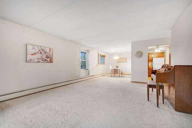 sitting room featuring carpet, ceiling fan, and a baseboard radiator