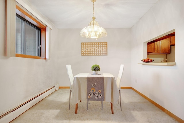 carpeted dining room featuring baseboard heating and a chandelier