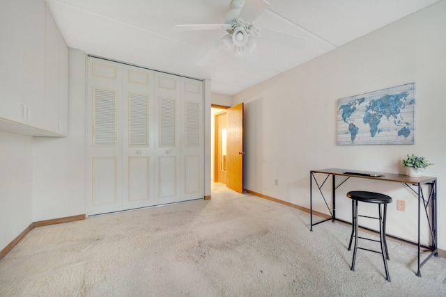 interior space with light carpet and ceiling fan