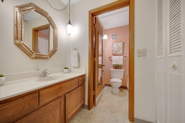 bathroom with vanity and toilet