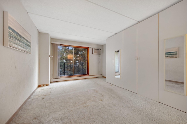 carpeted empty room featuring baseboard heating and a wall mounted AC