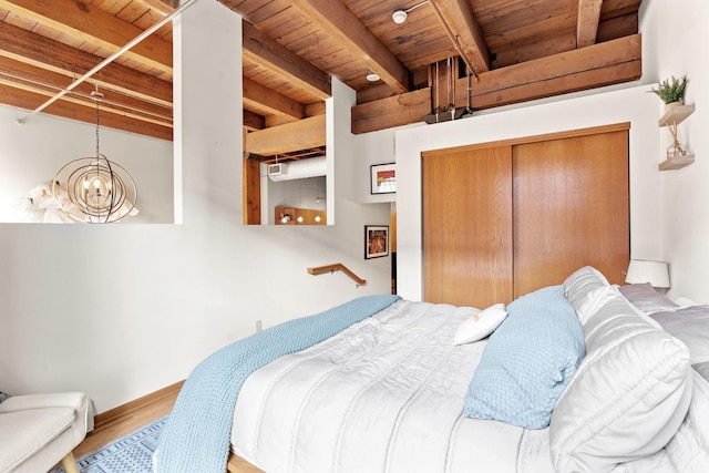 bedroom featuring wood ceiling, hardwood / wood-style flooring, a closet, beam ceiling, and a notable chandelier