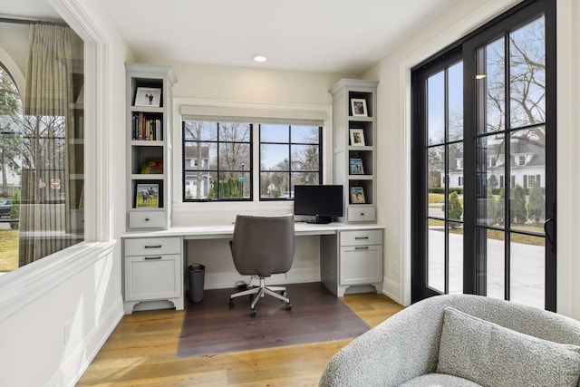 office area featuring built in desk and light wood-type flooring