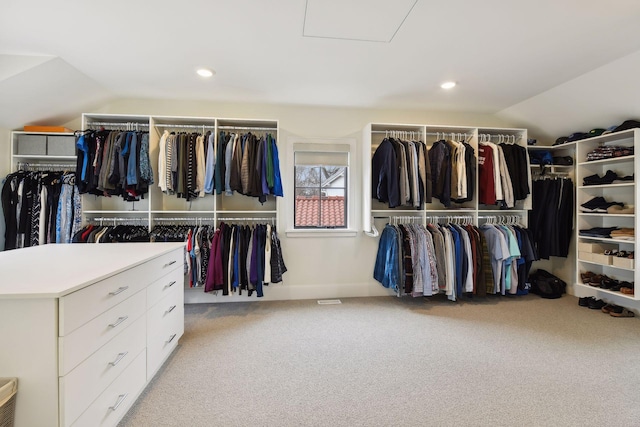 spacious closet featuring light colored carpet and lofted ceiling