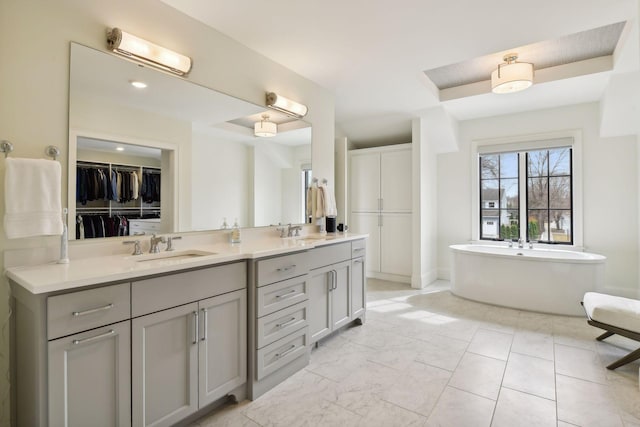 bathroom featuring vanity and a washtub