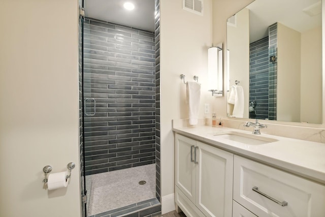 bathroom featuring vanity and a tile shower