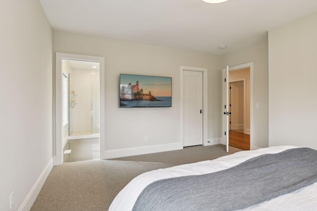 bedroom featuring dark colored carpet and ensuite bath