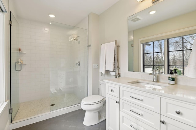 bathroom featuring vanity, an enclosed shower, tile patterned floors, and toilet