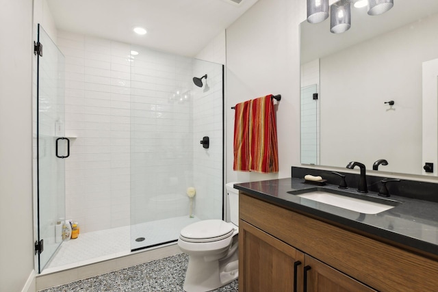 bathroom featuring vanity, an enclosed shower, and toilet