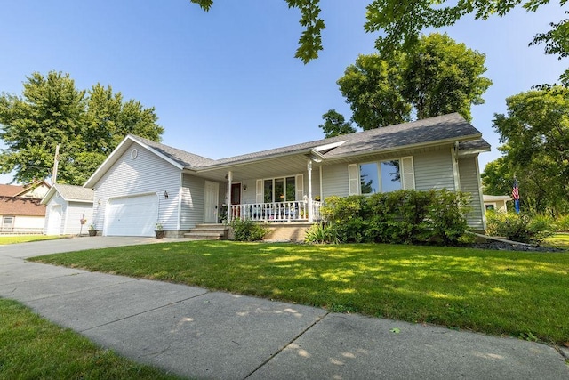 ranch-style home featuring a garage, covered porch, and a front yard