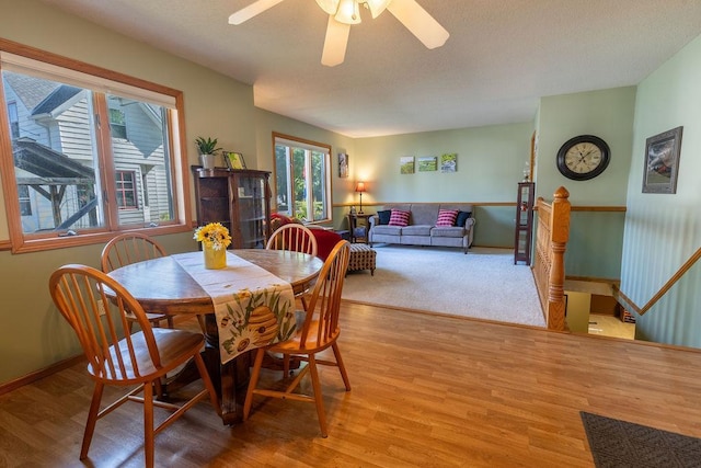 dining space featuring light wood-type flooring and ceiling fan