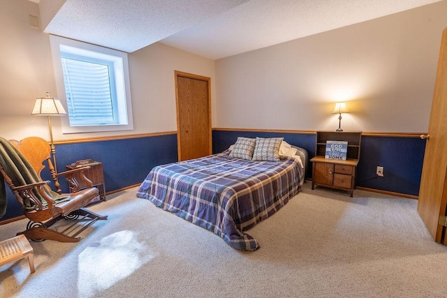 carpeted bedroom with a textured ceiling