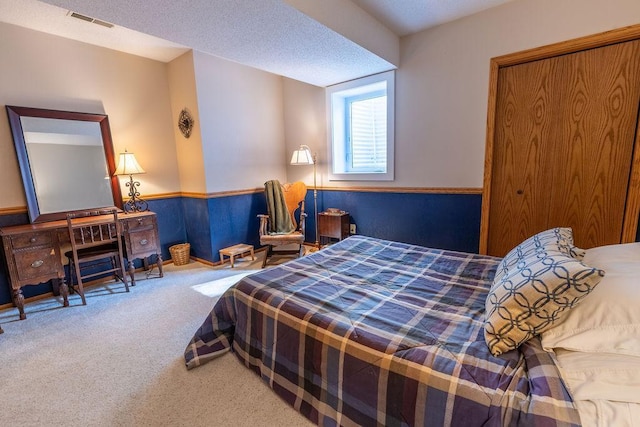 carpeted bedroom featuring a textured ceiling