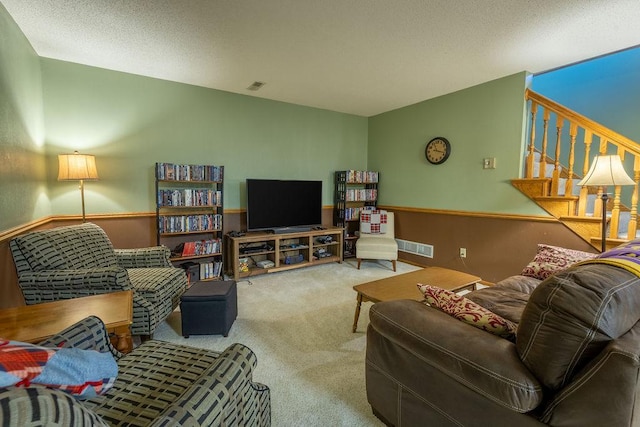 living room featuring carpet flooring and a textured ceiling