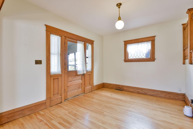 entrance foyer featuring baseboards, visible vents, and light wood-style floors