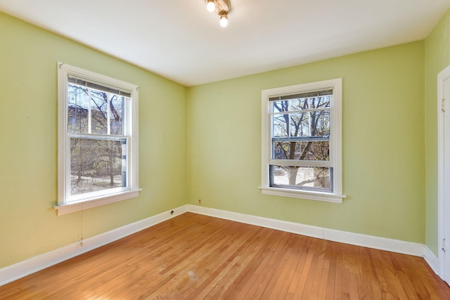 unfurnished room featuring light wood-style floors and baseboards