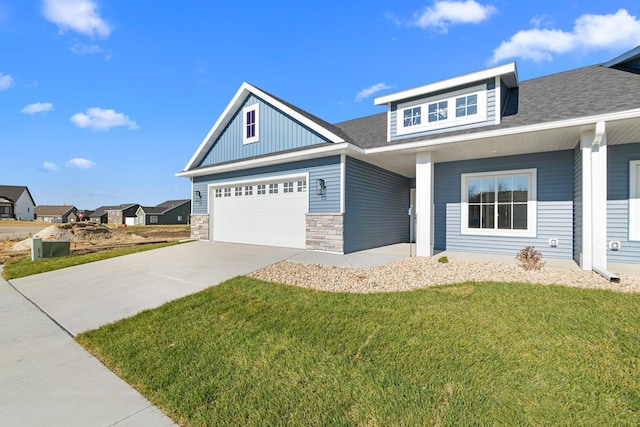 craftsman-style home with a garage and a front lawn