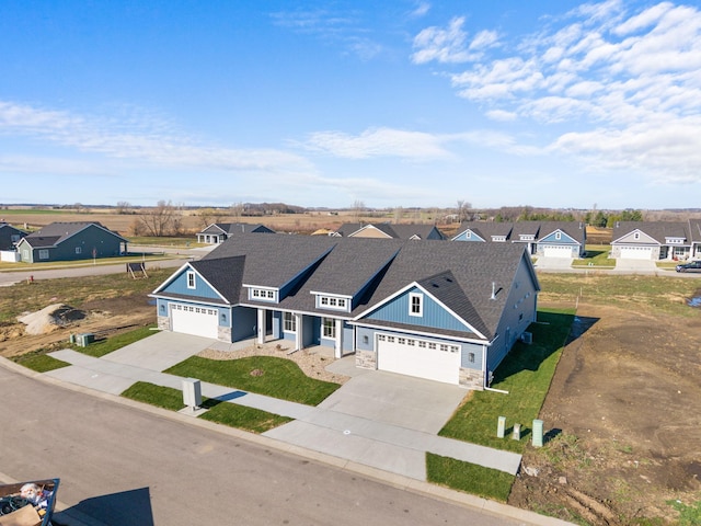 1003 11th Pl NW, Kasson, MN 55944 - view of front of property featuring stone siding, driveway, and a residential view