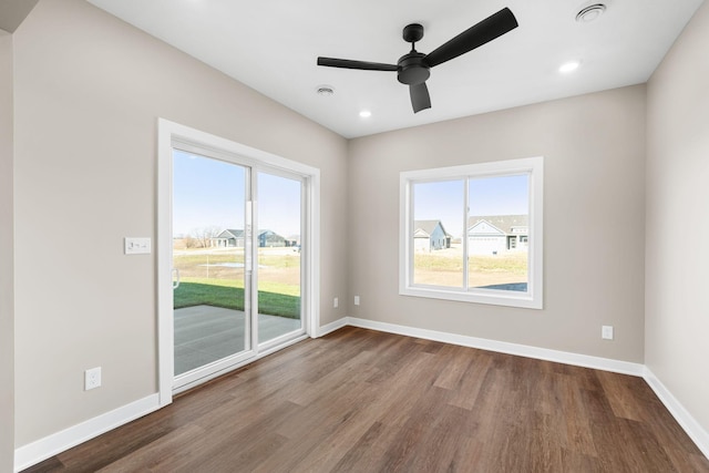 1003 11th Pl NW, Kasson, MN 55944 - empty room featuring wood finished floors, plenty of natural light, baseboards, and recessed lighting