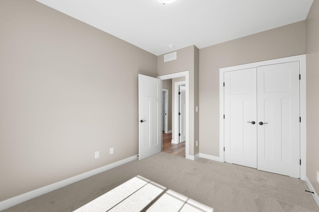 unfurnished bedroom featuring carpet floors and a closet