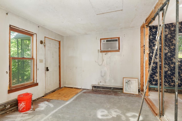 foyer entrance featuring a wall unit AC