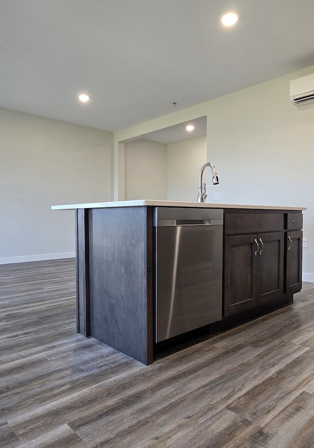 kitchen with a center island with sink, dishwasher, and dark hardwood / wood-style flooring