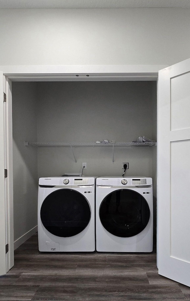 laundry room with separate washer and dryer and dark wood-type flooring