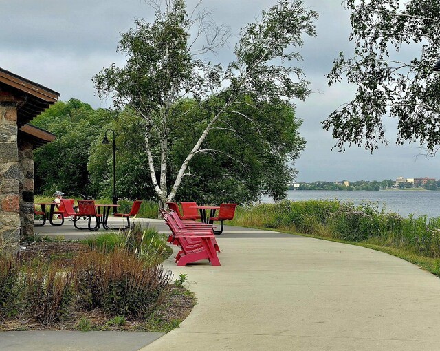 view of home's community featuring a water view and a patio