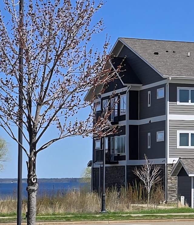 715 Lake Shore Dr NE Unit 113, Bemidji, MN 56601 - view of side of home featuring a water view and stone siding