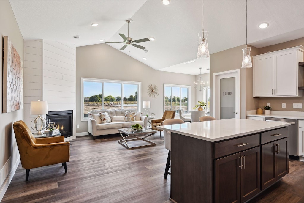 kitchen with ceiling fan with notable chandelier, dark brown cabinets, dark hardwood / wood-style flooring, hanging light fixtures, and white cabinetry