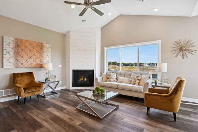 living room featuring dark hardwood / wood-style flooring, high vaulted ceiling, ceiling fan, and a large fireplace